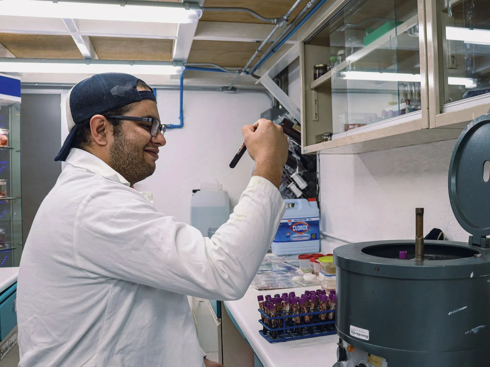 A researcher adjusts equipment in a laboratory.